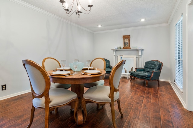 dining area featuring ornamental molding, wood-type flooring, a chandelier, and a textured ceiling