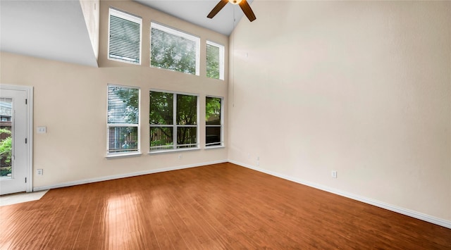 908 Englewood Ln, Plano, TX 75025 - unfurnished living room featuring ceiling fan, wood finished floors, and high vaulted ceiling