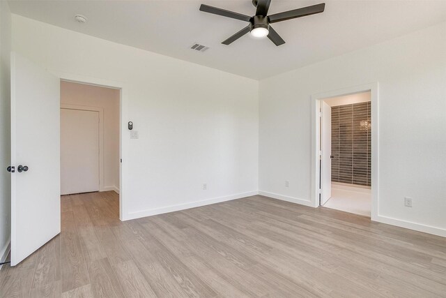 unfurnished room with baseboards, a ceiling fan, light wood-style flooring, and visible vents
