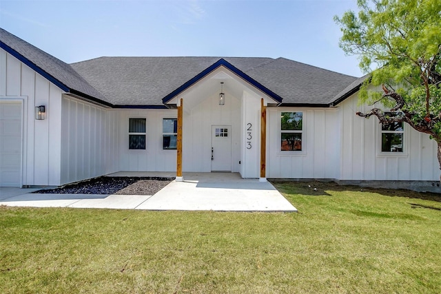 233 Lakeshore Dr, Runaway Bay, TX 76426 - entrance to property with board and batten siding, roof with shingles, and a lawn