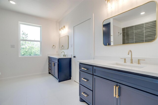 bathroom with a sink and two vanities