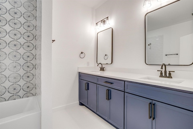 bathroom featuring a sink, a washtub, walk in shower, and double vanity