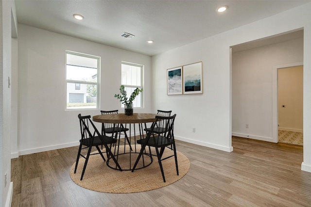 dining area featuring light wood-style floors, baseboards, recessed lighting, and visible vents