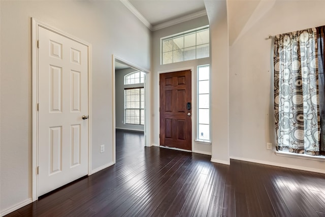 entryway featuring ornamental molding, baseboards, and dark wood-style floors