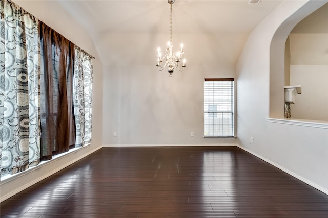 unfurnished dining area with arched walkways, visible vents, hardwood / wood-style floors, lofted ceiling, and a notable chandelier