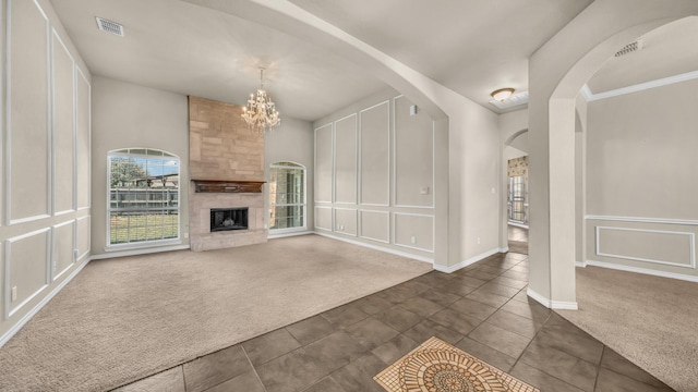 8708 Tangleridge Dr, Fort Worth, TX 76123 - unfurnished living room with dark carpet, dark tile patterned floors, a chandelier, arched walkways, and a large fireplace