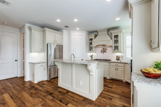 617 Denton Creek Dr, Mckinney, TX 75072 - kitchen featuring stainless steel appliances, custom exhaust hood, visible vents, and dark wood finished floors