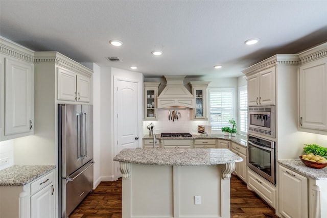 617 Denton Creek Dr, Mckinney, TX 75072 - kitchen featuring tasteful backsplash, visible vents, appliances with stainless steel finishes, dark wood-style floors, and custom range hood