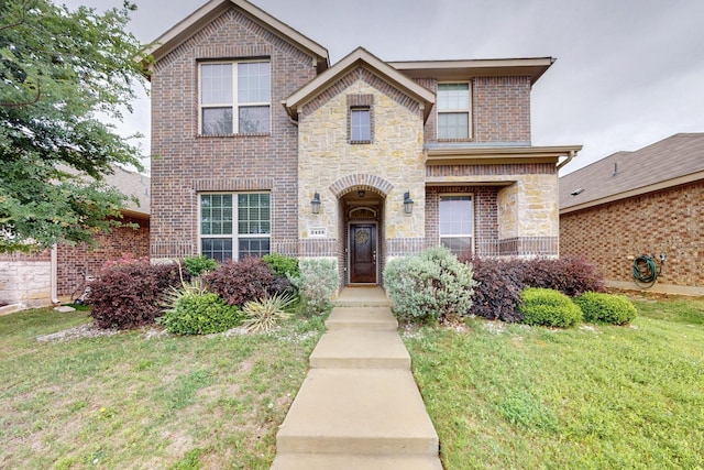 2425 Larimar Dr, Little Elm, TX 76227 - view of front facade featuring brick siding, a front lawn, and stone siding