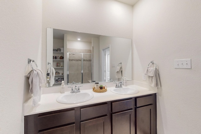 2425 Larimar Dr, Little Elm, TX 76227 - bathroom with double vanity, a stall shower, and a textured wall