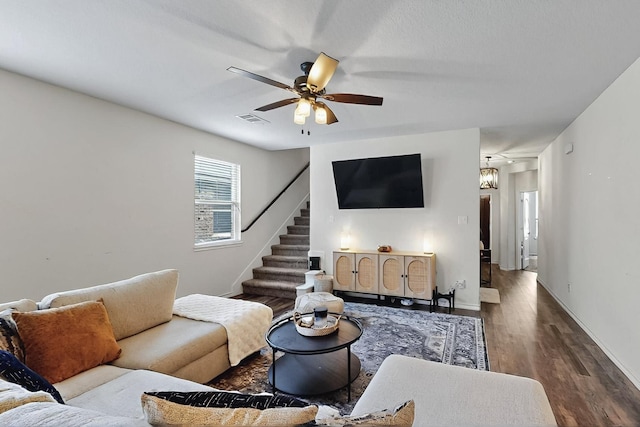 living area with ceiling fan, wood finished floors, stairway, and baseboards