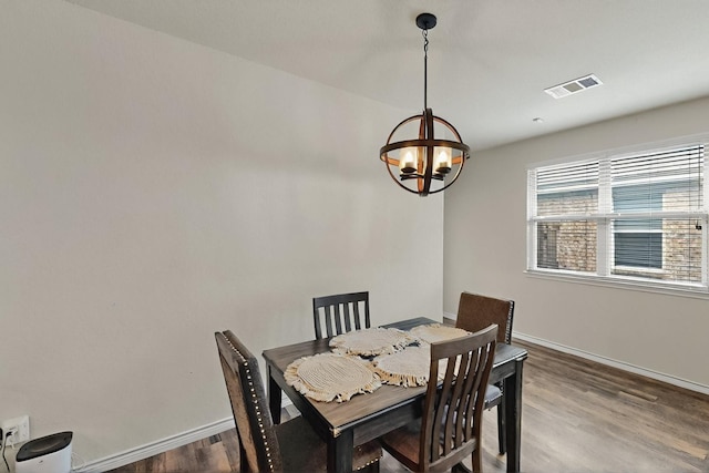 2425 Larimar Dr, Little Elm, TX 76227 - dining area with baseboards, a chandelier, and wood finished floors