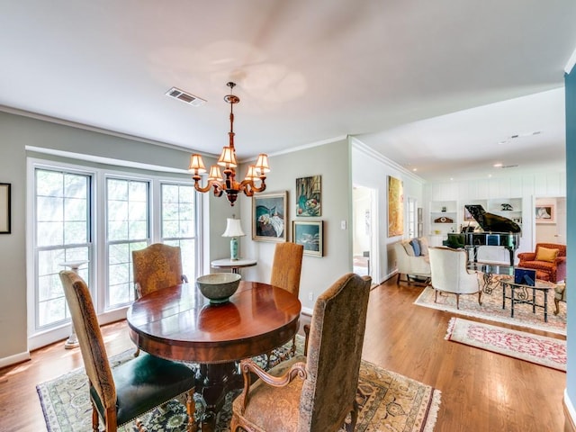 705 W Colorado Blvd, Dallas, TX 75208 - dining room featuring a chandelier, ornamental molding, wood finished floors, and baseboards