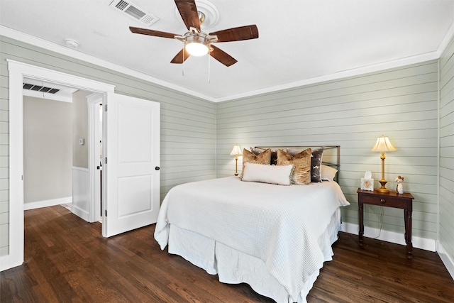 bedroom featuring visible vents, baseboards, and wood finished floors