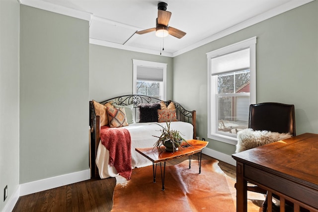 bedroom featuring a ceiling fan, crown molding, baseboards, and multiple windows