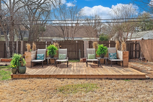 wooden terrace featuring a fenced backyard