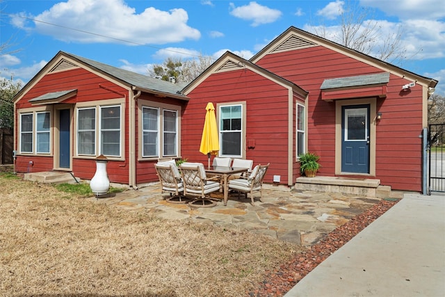 rear view of house featuring a patio area, entry steps, and fence