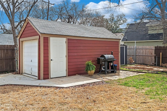 view of shed featuring fence