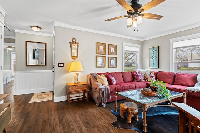 living area with crown molding, ceiling fan, plenty of natural light, and wood finished floors