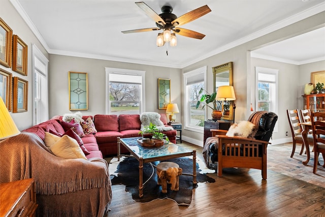 living room with a ceiling fan, wood finished floors, and a healthy amount of sunlight
