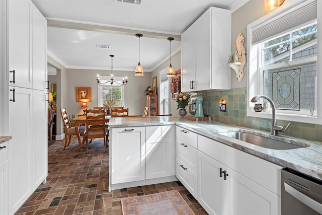 kitchen with a sink, visible vents, brick patterned floor, and dishwasher