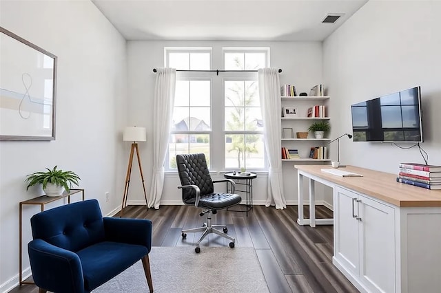office space featuring baseboards, dark wood-style floors, and visible vents