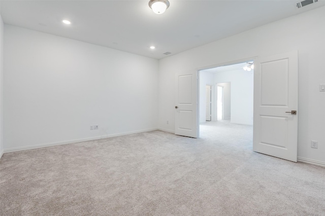 empty room with visible vents, baseboards, recessed lighting, and light colored carpet