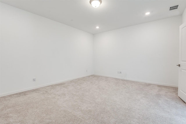 carpeted empty room featuring visible vents, baseboards, and recessed lighting