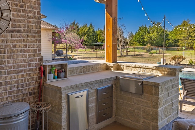 4682 County Road 2720, Caddo Mills, TX 75135 - view of patio featuring fence and exterior kitchen