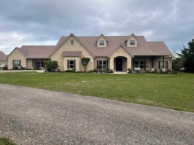4682 County Road 2720, Caddo Mills, TX 75135 - french country style house with metal roof, stone siding, and a front lawn