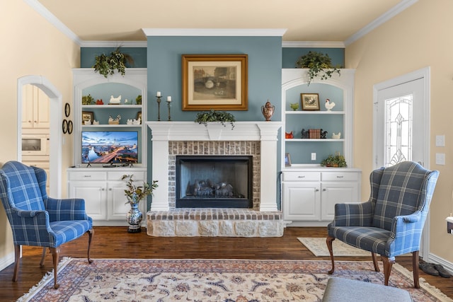 4682 County Road 2720, Caddo Mills, TX 75135 - sitting room with ornamental molding, built in shelves, a brick fireplace, and wood finished floors