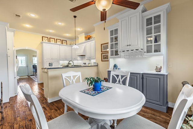 4682 County Road 2720, Caddo Mills, TX 75135 - dining space featuring visible vents, ceiling fan, arched walkways, and dark wood finished floors