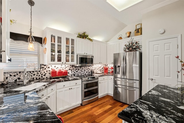1412 Conejos Ct, Granbury, TX 76048 - kitchen with decorative backsplash, white cabinetry, a sink, appliances with stainless steel finishes, and decorative light fixtures