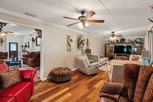 1412 Conejos Ct, Granbury, TX 76048 - living area featuring visible vents, a ceiling fan, wood finished floors, and ornamental molding