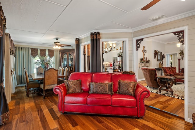 1412 Conejos Ct, Granbury, TX 76048 - living room with visible vents, crown molding, ceiling fan with notable chandelier, and wood finished floors