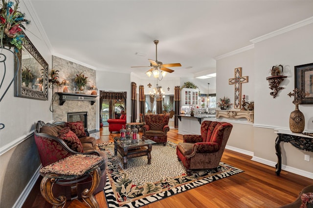 1412 Conejos Ct, Granbury, TX 76048 - living area with a ceiling fan, ornamental molding, a stone fireplace, and wood finished floors