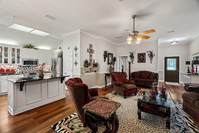 1412 Conejos Ct, Granbury, TX 76048 - living area with visible vents, a ceiling fan, crown molding, and wood finished floors