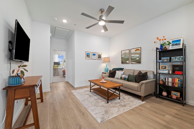 living area featuring baseboards, light wood-type flooring, recessed lighting, attic access, and ceiling fan