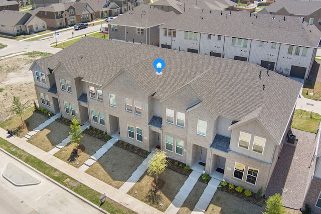 birds eye view of property with a residential view