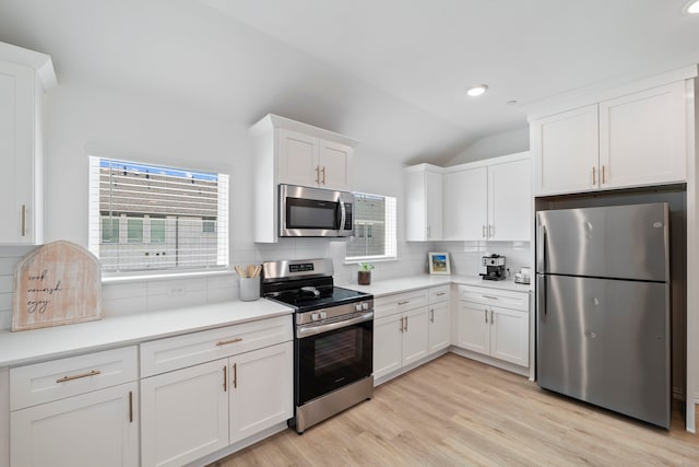kitchen featuring backsplash, white cabinetry, recessed lighting, and stainless steel appliances