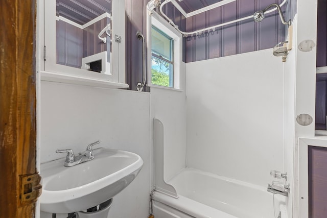 full bathroom with a sink