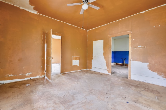 empty room with unfinished concrete floors and ceiling fan
