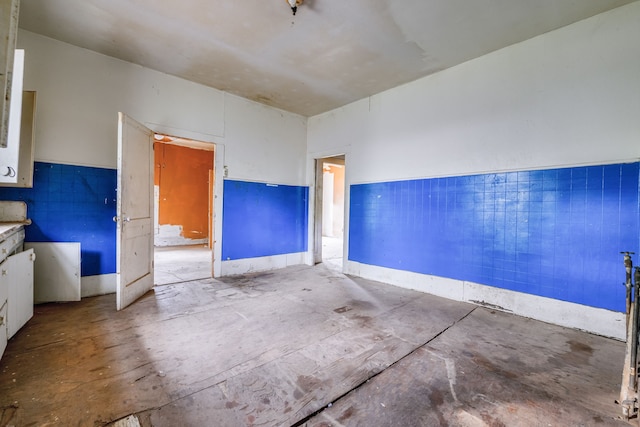 unfurnished room with unfinished concrete floors