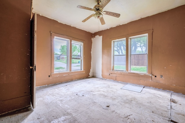 spare room featuring a ceiling fan and a healthy amount of sunlight