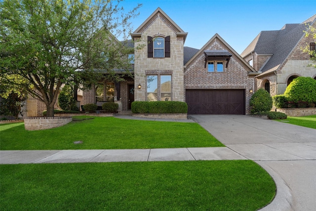 view of front of home with brick siding, driveway, stone siding, and a front lawn