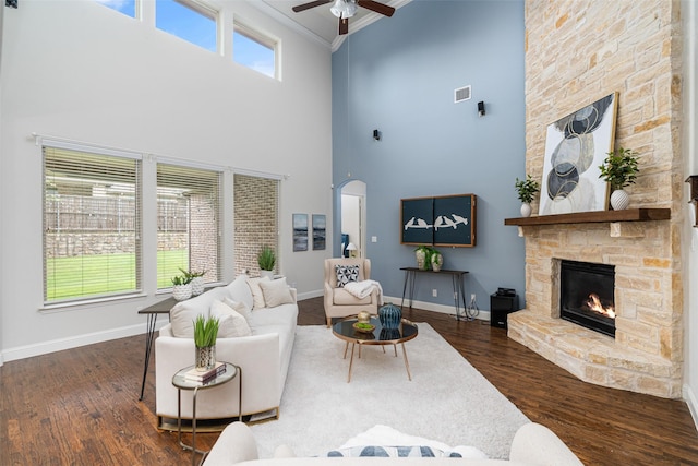 313 Grove Park Pl, Mckinney, TX 75071 - living room with a fireplace, a high ceiling, ceiling fan, ornamental molding, and wood finished floors