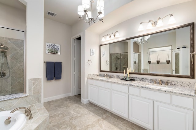 full bathroom with baseboards, a shower stall, a sink, and a chandelier