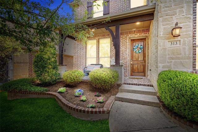 313 Grove Park Pl, Mckinney, TX 75071 - view of exterior entry with brick siding and a porch
