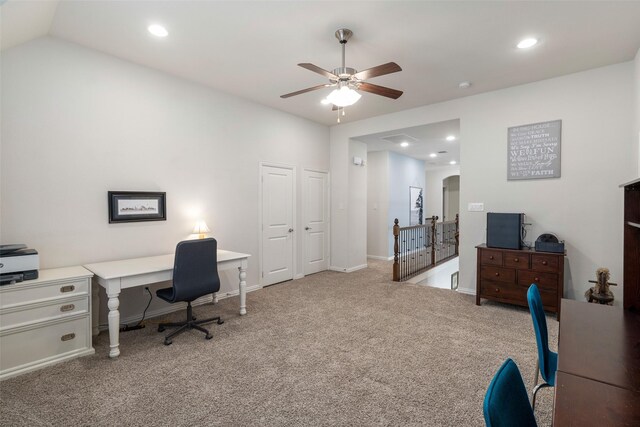 carpeted office space featuring recessed lighting, arched walkways, baseboards, and ceiling fan