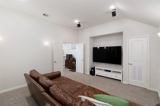 carpeted living area with visible vents, baseboards, and lofted ceiling